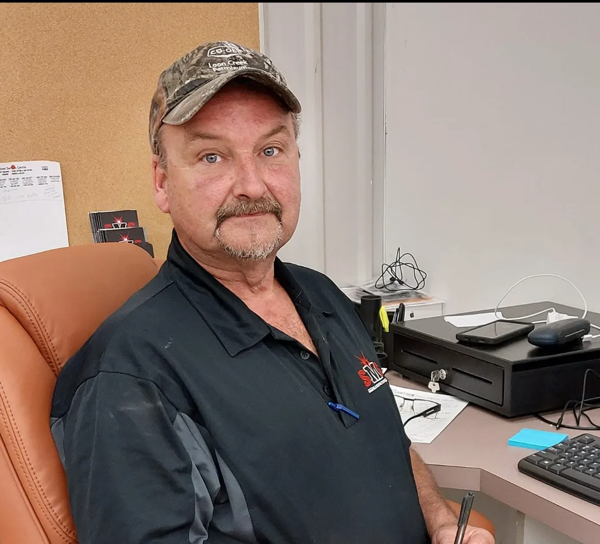 Greg from the SMS Manufacturing parts department at his desk